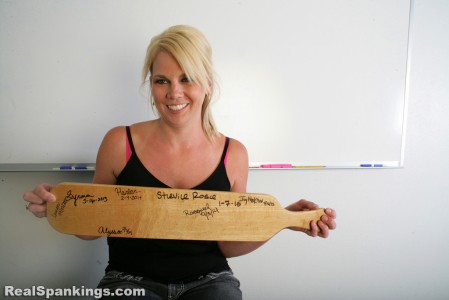 Showing her signature on the paddle.